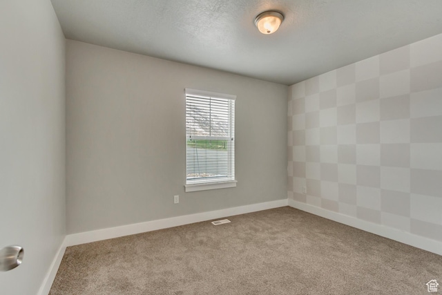 462 S 1430 E Unit 114, Tooele, UT 84074 - spare room featuring a textured ceiling, carpet floors, visible vents, and baseboards