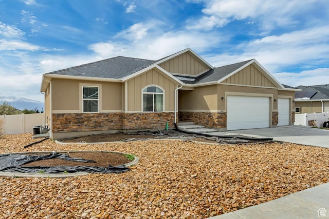 462 S 1430 E Unit 114, Tooele, UT 84074 - view of front of property with a garage, central AC unit, stone siding, and fence