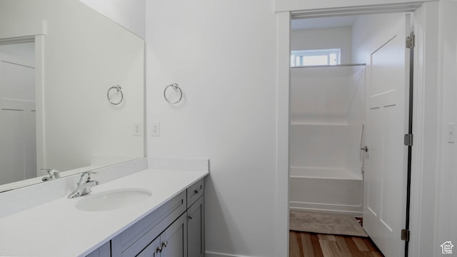 1984 N 3410 W Unit R102, Lehi, UT 84043 - bathroom featuring shower / washtub combination, baseboards, vanity, and wood finished floors