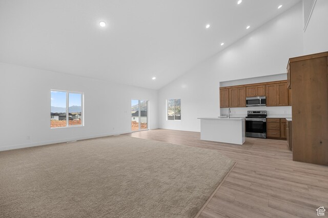 1975 S Marigold Way Unit 433, Santaquin, UT 84655 - unfurnished living room with high vaulted ceiling, plenty of natural light, recessed lighting, and light wood-type flooring