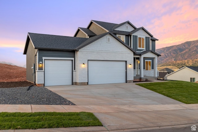 1975 S Marigold Way Unit 433, Santaquin, UT 84655 - view of front facade with an attached garage, concrete driveway, a mountain view, a shingled roof, and a lawn