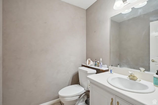 bathroom featuring toilet and vanity
