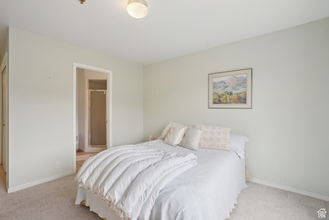 bedroom featuring light colored carpet and baseboards