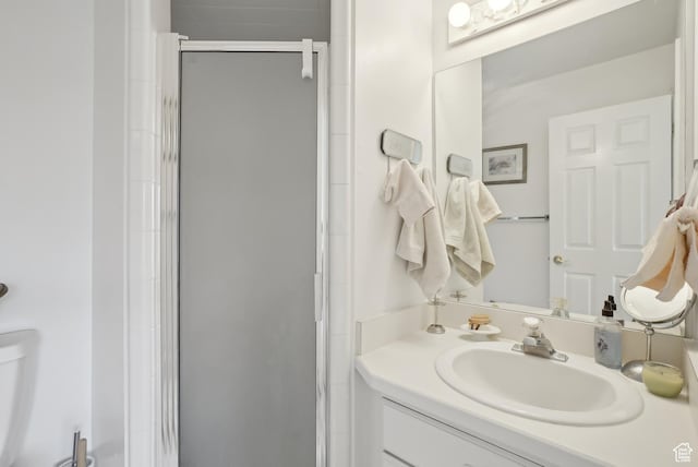 bathroom featuring a shower stall and vanity