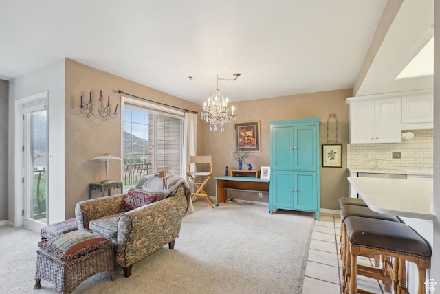 living area featuring baseboards, an inviting chandelier, and light carpet