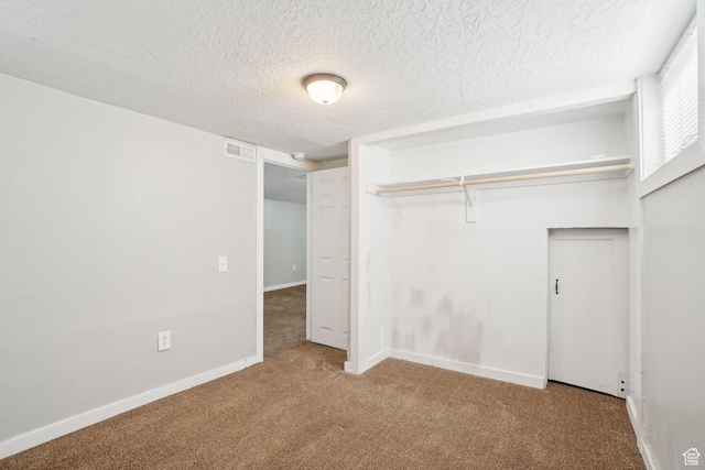2662 Jackson Ave, Ogden, UT 84401 - unfurnished bedroom featuring a closet, carpet floors, a textured ceiling, and baseboards