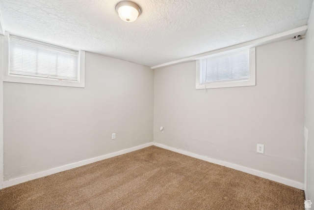 2662 Jackson Ave, Ogden, UT 84401 - below grade area featuring a textured ceiling, carpet flooring, and baseboards