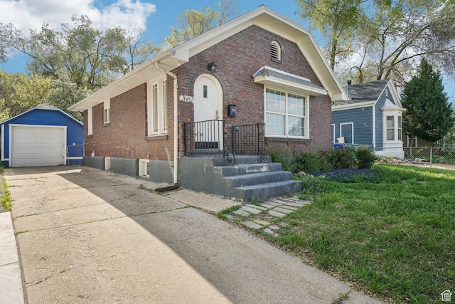 2662 Jackson Ave, Ogden, UT 84401 - view of front of home with concrete driveway, an outdoor structure, fence, a garage, and brick siding