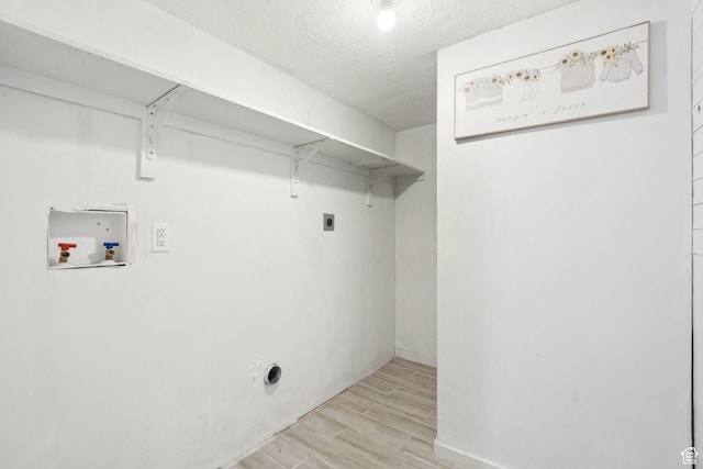 2662 Jackson Ave, Ogden, UT 84401 - clothes washing area with a textured ceiling, hookup for an electric dryer, hookup for a washing machine, wood finish floors, and laundry area