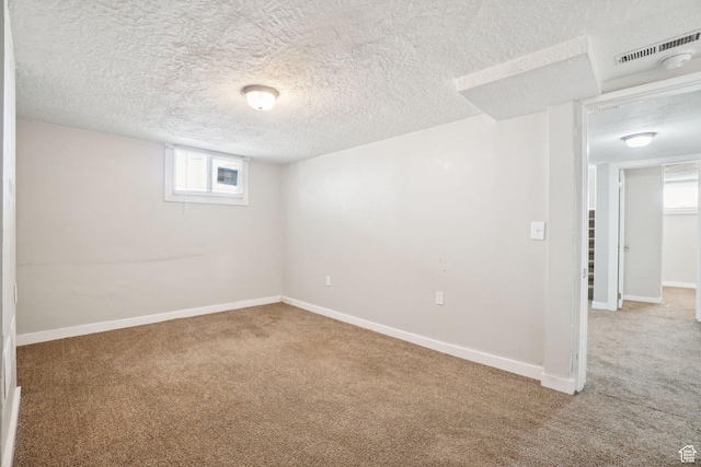 2662 Jackson Ave, Ogden, UT 84401 - basement with visible vents, baseboards, carpet flooring, and a textured ceiling