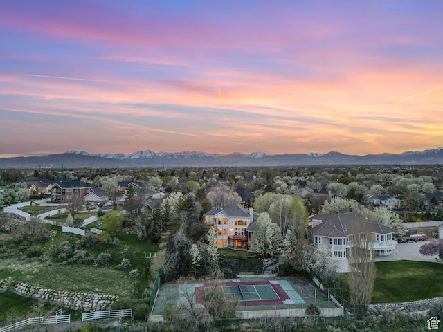 aerial view at dusk with a mountain view and a residential view