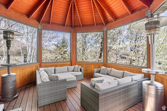 wooden terrace with an outdoor living space and a gazebo
