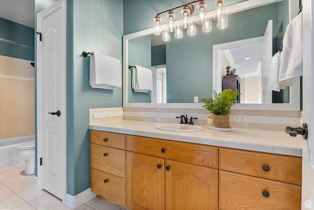 full bath with vanity, toilet, tile patterned flooring, and washtub / shower combination