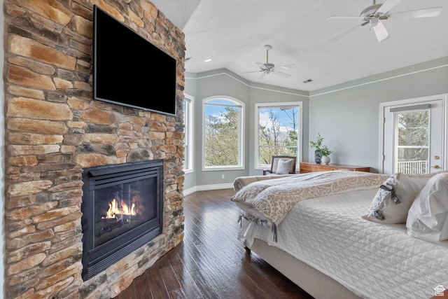 bedroom featuring lofted ceiling, baseboards, dark wood-style floors, and multiple windows