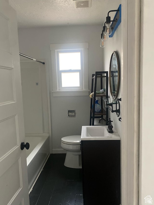 full bathroom with tile patterned floors, a textured ceiling, vanity, toilet, and visible vents