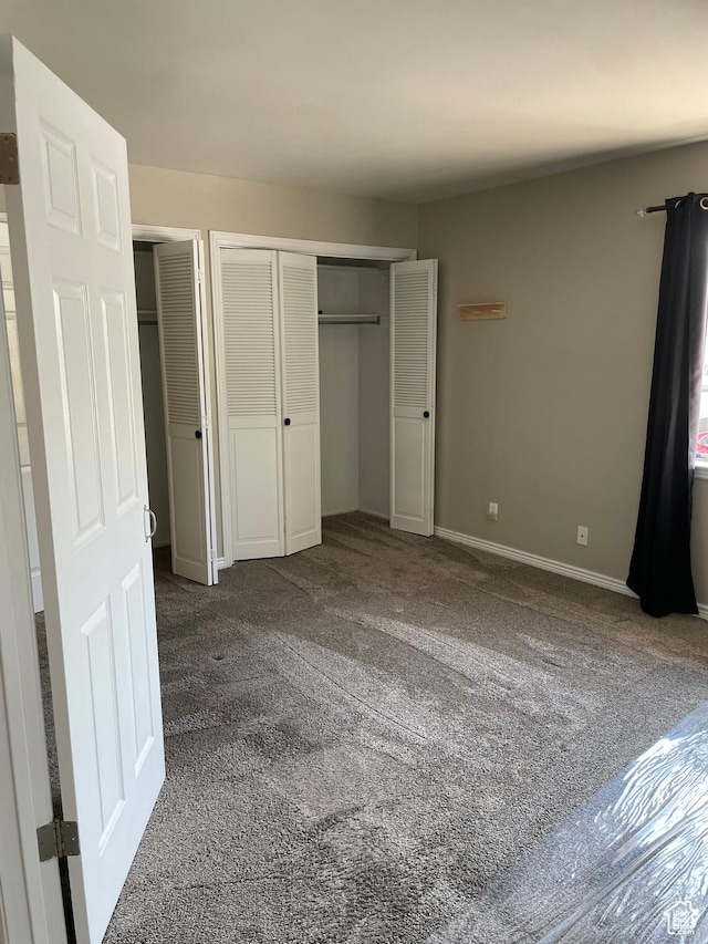 1525 E 5700 S, Murray, UT 84121 - unfurnished bedroom with dark colored carpet, two closets, and baseboards