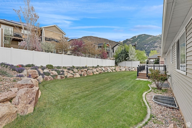 2838 N 1375 E, North Ogden, UT 84414 - view of yard featuring a fenced backyard, a deck with mountain view, and a residential view