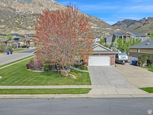 2838 N 1375 E, North Ogden, UT 84414 - view of front of property with a mountain view, driveway, a garage, brick siding, and a front yard