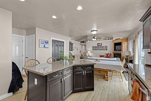 2838 N 1375 E, North Ogden, UT 84414 - kitchen with open floor plan, a ceiling fan, a textured ceiling, and a kitchen island