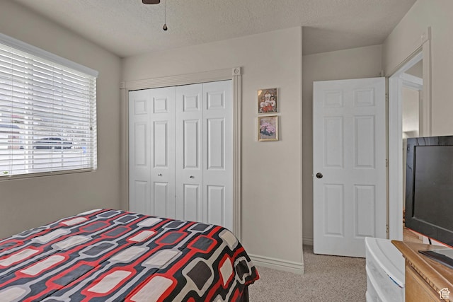 2838 N 1375 E, North Ogden, UT 84414 - bedroom featuring a textured ceiling, baseboards, light colored carpet, a closet, and ceiling fan