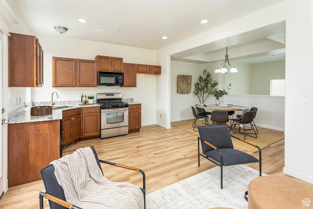 917 W Willow Bend Way, Farmington, UT 84025 - kitchen with a notable chandelier, black microwave, stainless steel gas stove, and brown cabinetry
