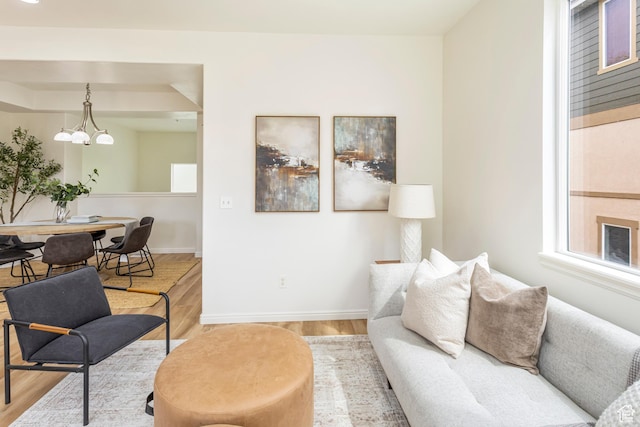 917 W Willow Bend Way, Farmington, UT 84025 - living area with baseboards, wood finished floors, and a notable chandelier