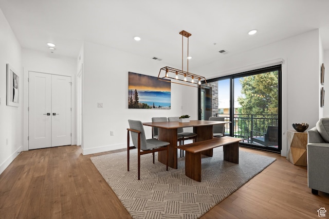 dining room with visible vents, baseboards, wood finished floors, and recessed lighting