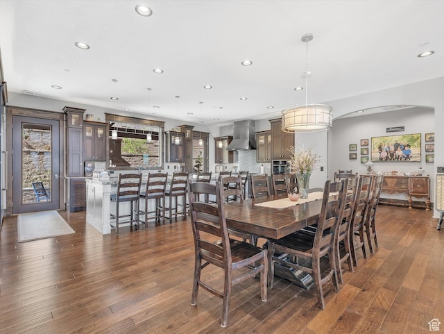 15146 S Secret Canyon Cir, Herriman, UT 84096 - dining space with recessed lighting, arched walkways, and dark wood-style flooring