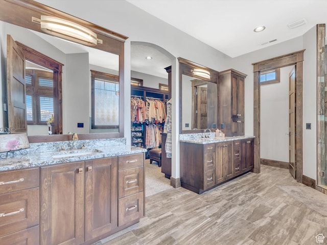 15146 S Secret Canyon Cir, Herriman, UT 84096 - bathroom with two vanities, visible vents, baseboards, and a sink