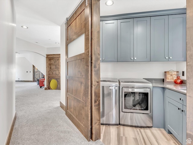 15146 S Secret Canyon Cir, Herriman, UT 84096 - laundry room with arched walkways, cabinet space, light colored carpet, washing machine and dryer, and recessed lighting