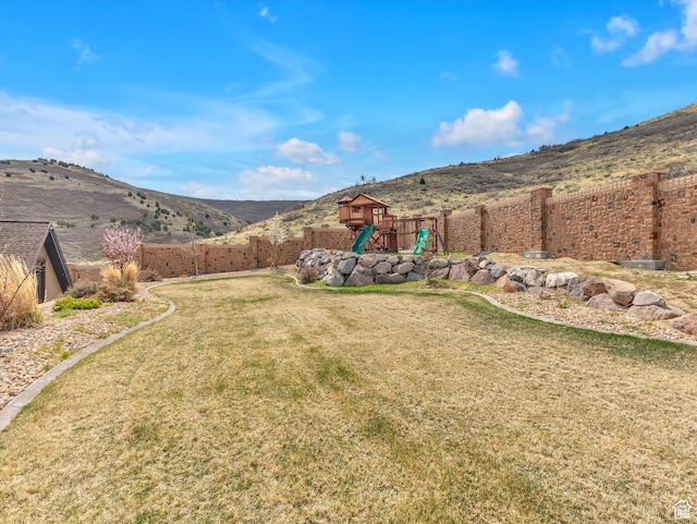 15146 S Secret Canyon Cir, Herriman, UT 84096 - view of yard featuring a fenced backyard, a mountain view, and a playground