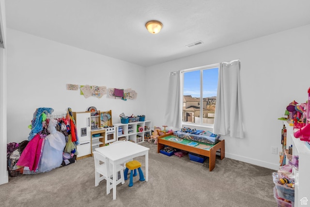 recreation room with baseboards, visible vents, and carpet