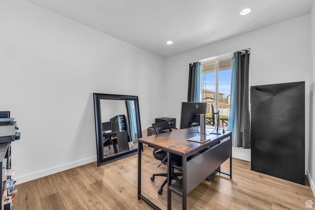 office space featuring light wood-style flooring, baseboards, and recessed lighting