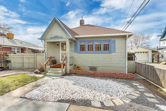 2481 Van Buren Ave, Ogden, UT 84401 - bungalow with driveway, a chimney, fence, a garage, and a shingled roof