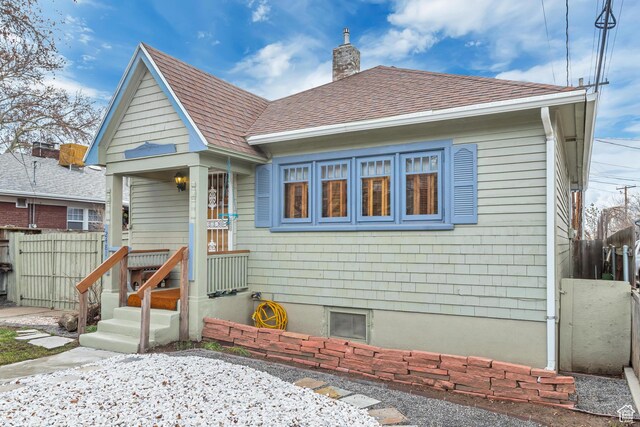 2481 Van Buren Ave, Ogden, UT 84401 - view of front of home featuring a chimney, fence, and a shingled roof