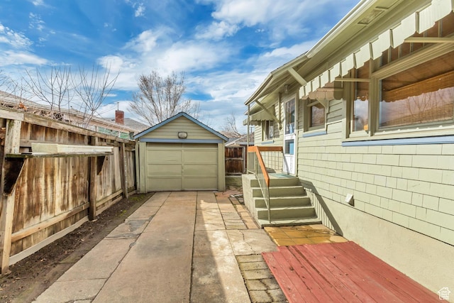 2481 Van Buren Ave, Ogden, UT 84401 - view of side of home featuring fence, an outbuilding, driveway, and a garage