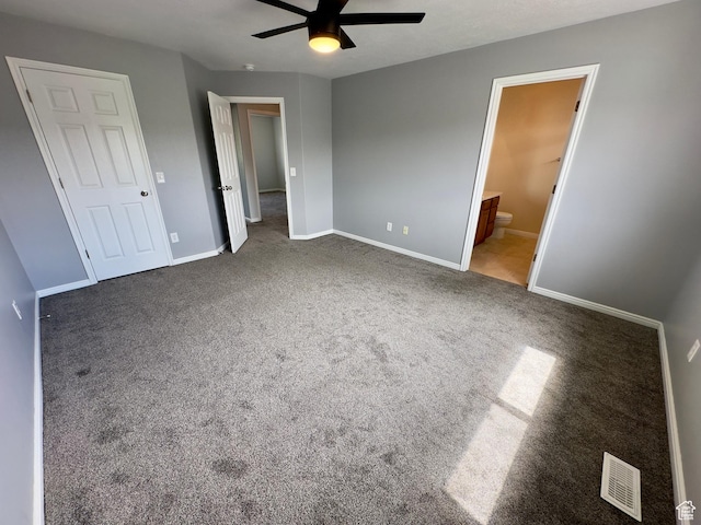 unfurnished bedroom featuring carpet, baseboards, ensuite bath, and ceiling fan