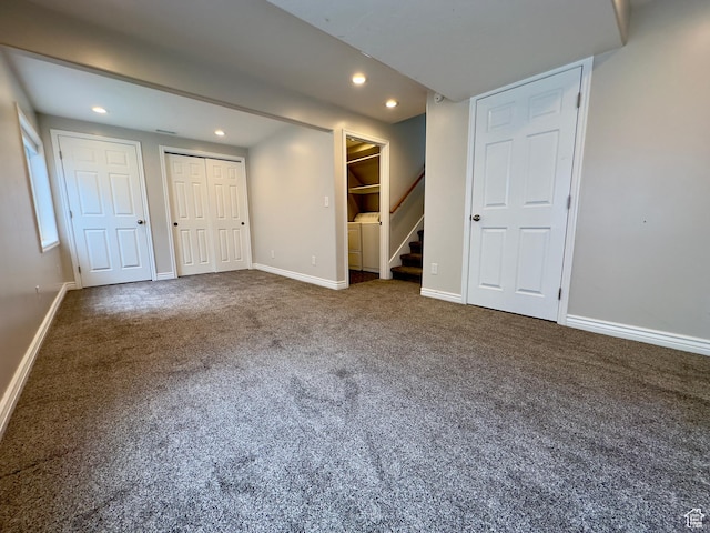 unfurnished bedroom with separate washer and dryer, recessed lighting, carpet flooring, and baseboards