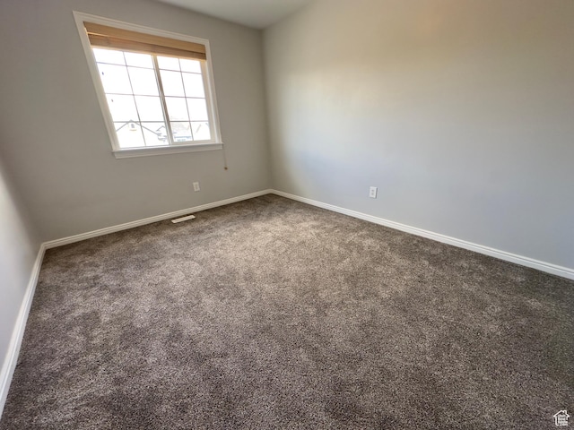 spare room with carpet flooring and baseboards
