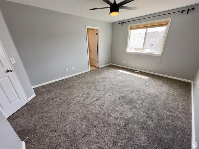 unfurnished bedroom with carpet, baseboards, ensuite bathroom, and a ceiling fan