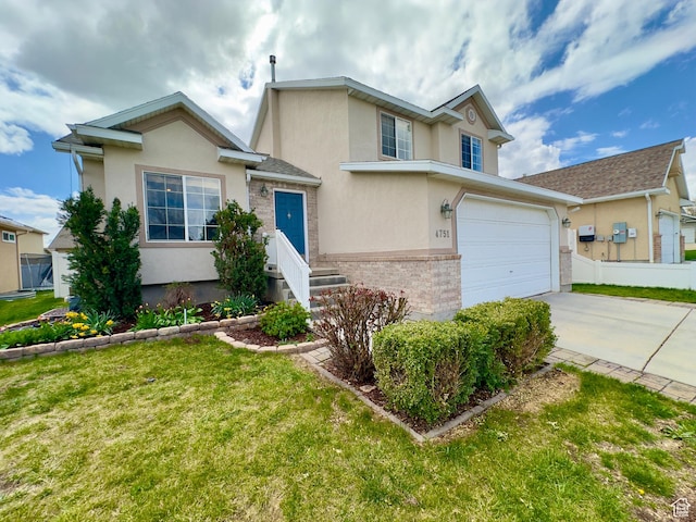 traditional-style house featuring stucco siding, concrete driveway, and an attached garage