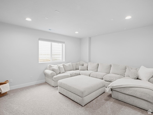living area with light colored carpet, recessed lighting, and baseboards