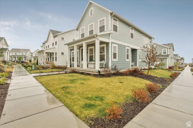 view of front of house with a porch, a front lawn, and a residential view