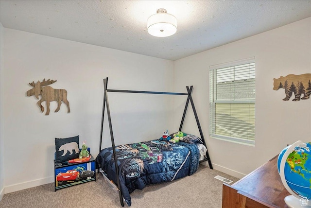 bedroom featuring baseboards, visible vents, and carpet floors
