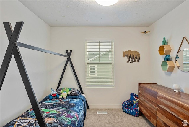 bedroom with baseboards, visible vents, and carpet flooring