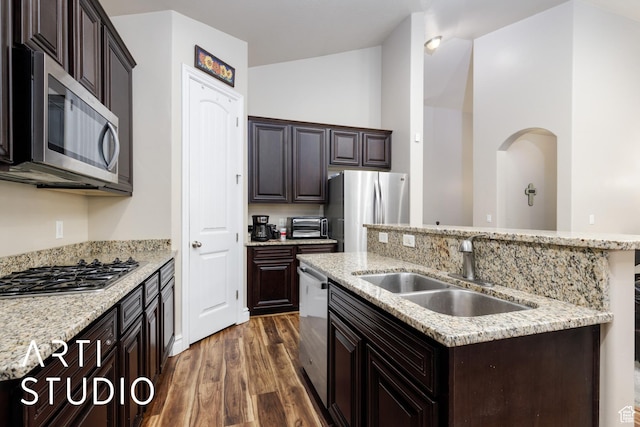 277 N Havenwood Dr W, Kaysville, UT 84037 - kitchen featuring stainless steel appliances, a sink, dark brown cabinetry, a center island with sink, and dark wood-style flooring