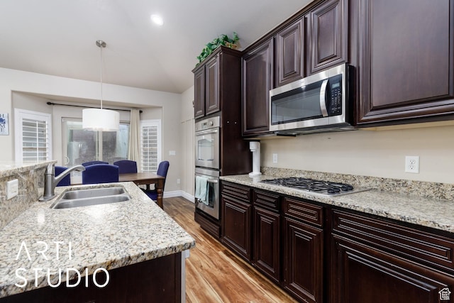 277 N Havenwood Dr W, Kaysville, UT 84037 - kitchen featuring dark brown cabinets, a sink, light wood-style floors, pendant lighting, and stainless steel appliances