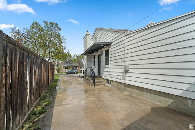 1131 W Simondi Ave N, Salt Lake City, UT 84116 - view of side of property featuring fence and a chimney