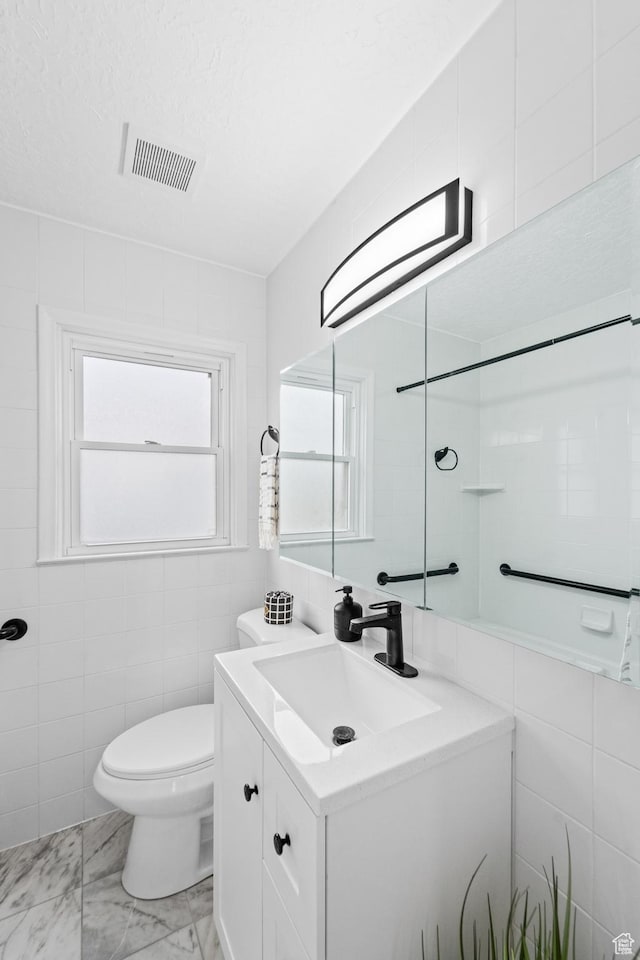 1131 W Simondi Ave N, Salt Lake City, UT 84116 - full bathroom with vanity, tile walls, marble finish floor, toilet, and visible vents