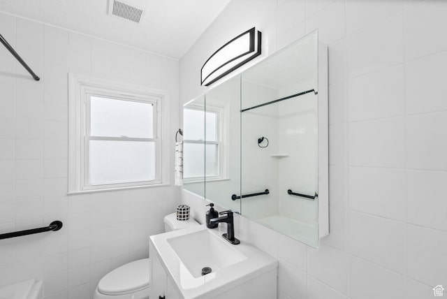 1131 W Simondi Ave N, Salt Lake City, UT 84116 - full bathroom featuring visible vents, toilet, vanity, tile walls, and walk in shower